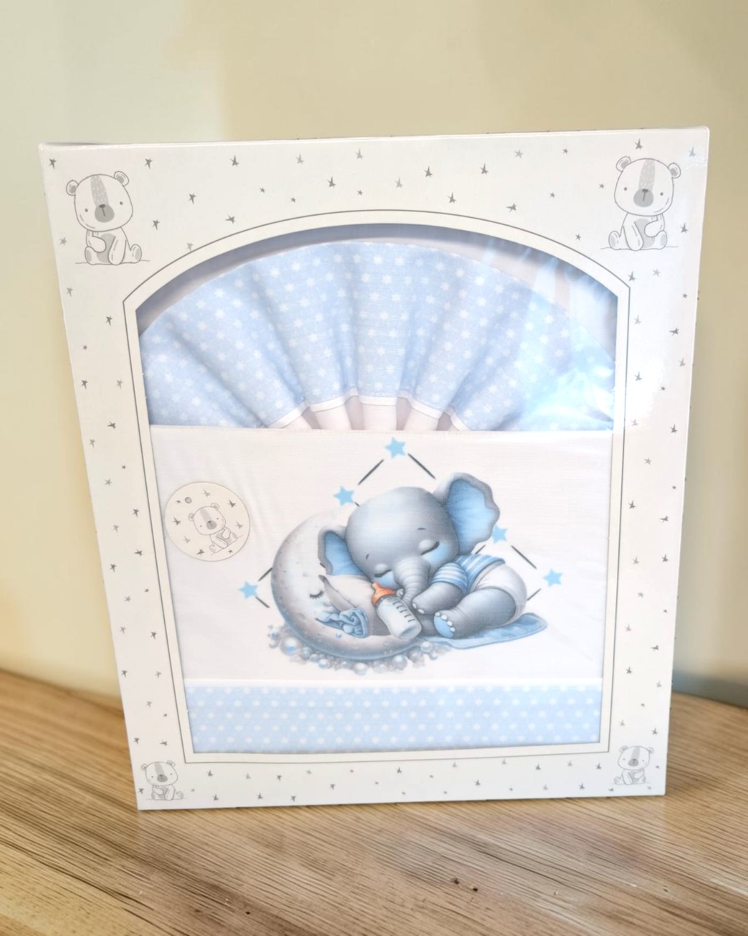 Conjunto de roupa de bebé azul com estrelas e elefante a dormir.