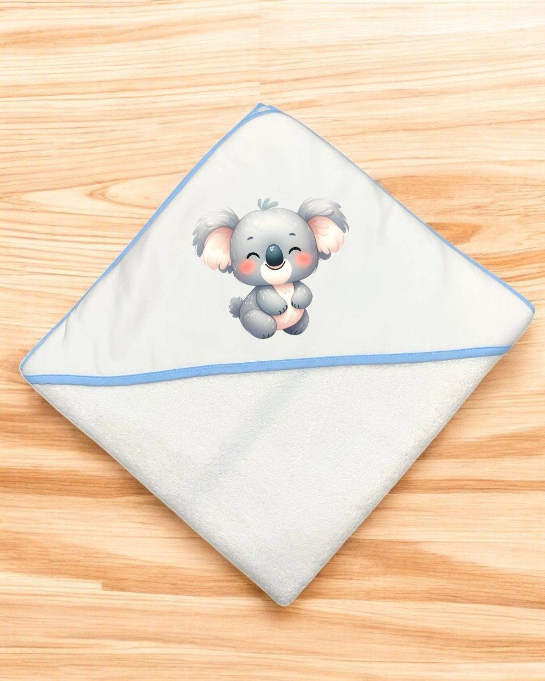 Toalha de bebé branca com borda azul e coala desenhado