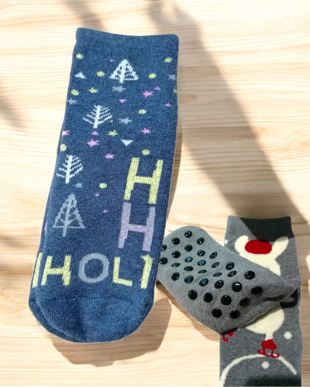 Meias antiderrapantes com padrões coloridos sobre fundo de madeira clara