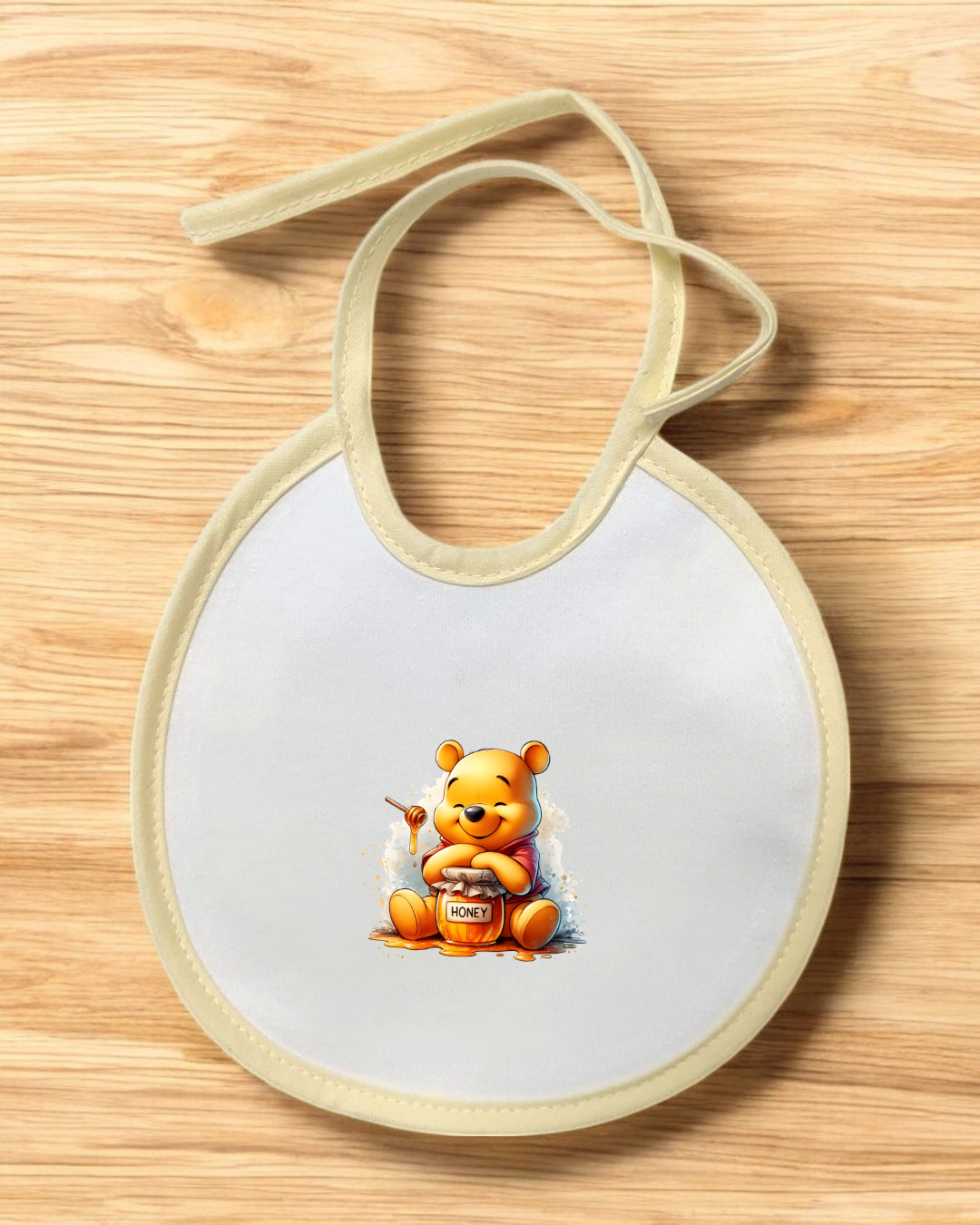 Babete de bebé com personagem urso e pote de mel