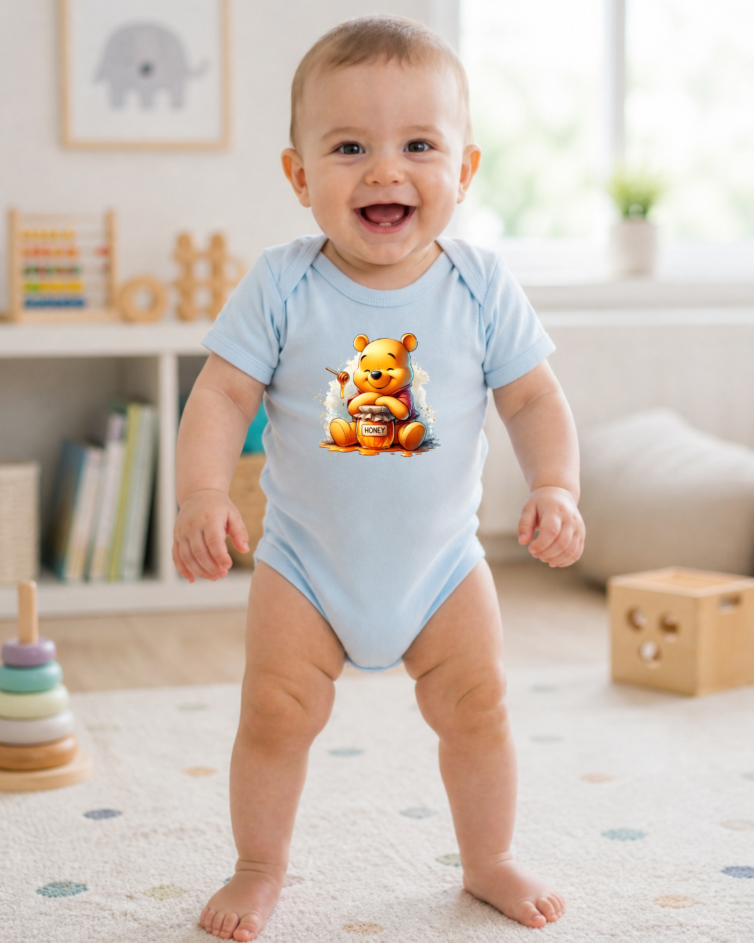 Bebé com body azul claro e estampa do Ursinho Pooh com pote de mel