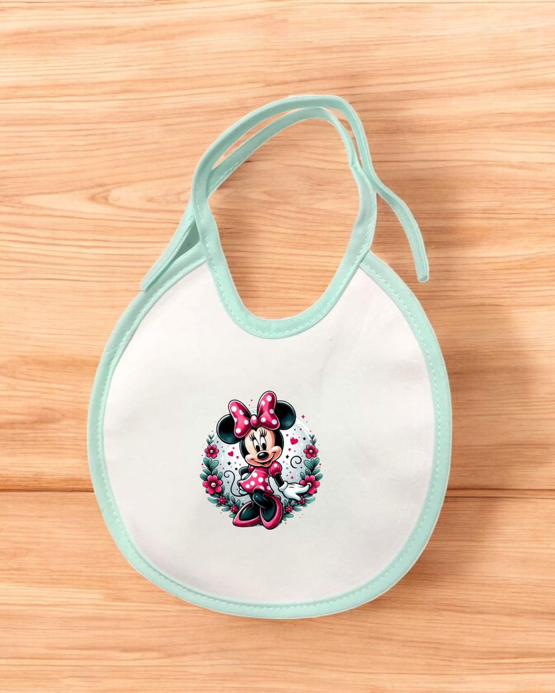 Babete de bebé branco com borda azul clara e estampa de Minnie Mouse