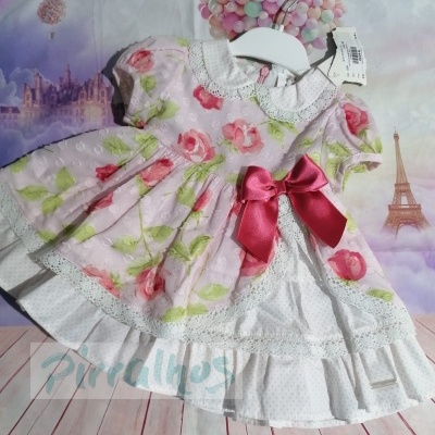 Vestido infantil rosa claro com padrão de rosas e laço rosa
