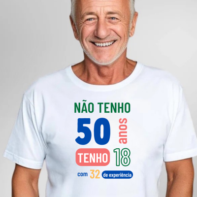 Homem idoso a sorrir com t-shirt branca com texto colorido impresso em português.