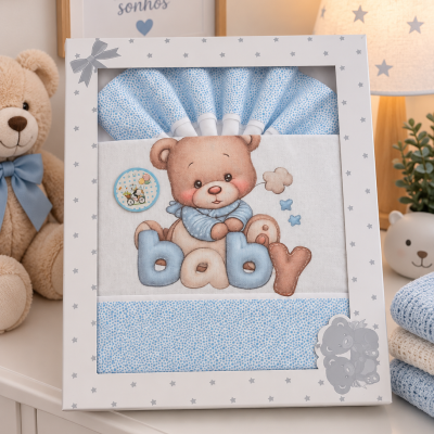 Conjunto de roupa de bebé azul com urso bordado e palavra baby numa caixa branca com estrelas cinzentas