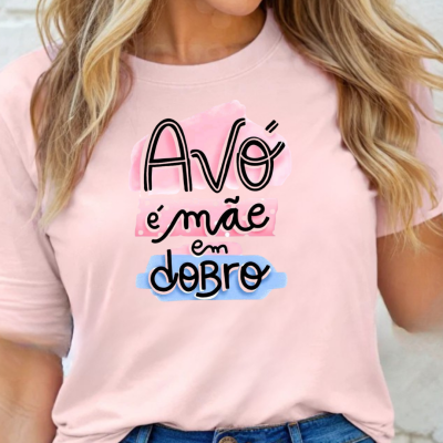 T-shirt rosa com texto colorido 'Avó é mãe em dobro', vista de mulher com jeans