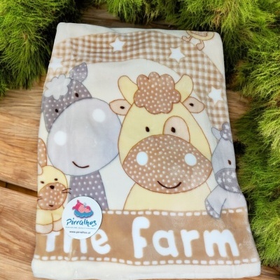 Manta bege e branca com estampa de animais da quinta e texto The Farm