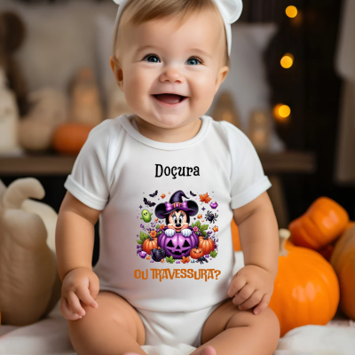 Bebé a vestir body branco com estampa colorida de Halloween e faixa branca com orelhas, sentado junto a abóboras.