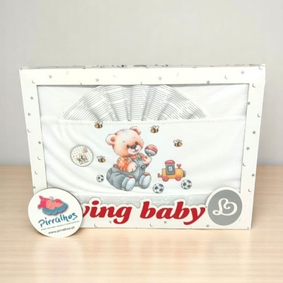 Conjunto de roupa de bebé com ursinho, bola e comboio, embalada em caixa branca com estrelas cinzentas