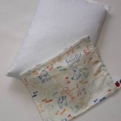 Almofada branca com capa estampada de cães e textos coloridos