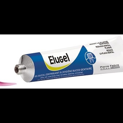 Tubo de creme dentário Elugel com creme rosa à frente