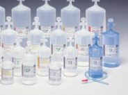 Frascos e garrafas transparentes com líquidos claros em fundo branco