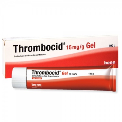 Embalagem e tubo de gel Thrombocid 15mg/g 100g bem visíveis em branco e vermelho