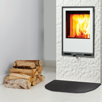 Lareira embutida com fogo aceso, azulejos brancos texturizados, lenha e tapete preto.