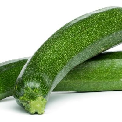 Três courgettes verdes frescas sobre fundo branco
