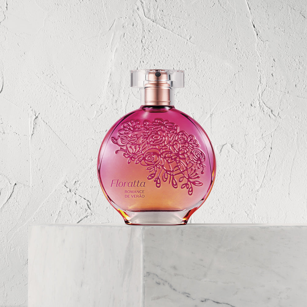 Frasco de perfume Floratta Romance de Vento em vidro redondo rosa e laranja com flores gravadas