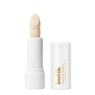 Bálsamo hidratante labial branco com tampa ao lado e produto texturizado