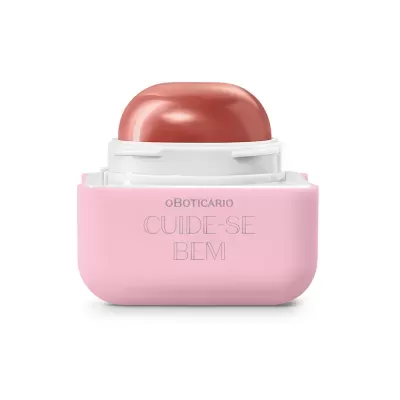 Embalagem rosa e branca de cosmético O Boticário Cuide-se Bem com aplicação cor de pêssego