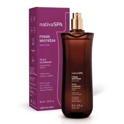 Frasco castanho com tampa dourada de óleo seco para corpo e cabelo junto à caixa roxa da nativaSPA rosas secretas.