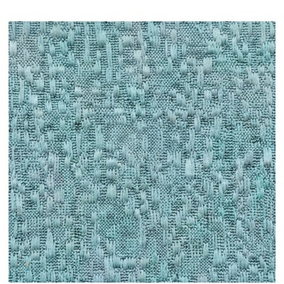 Pormenor de tecido azul claro com padrão texturizado e linhas em relevo