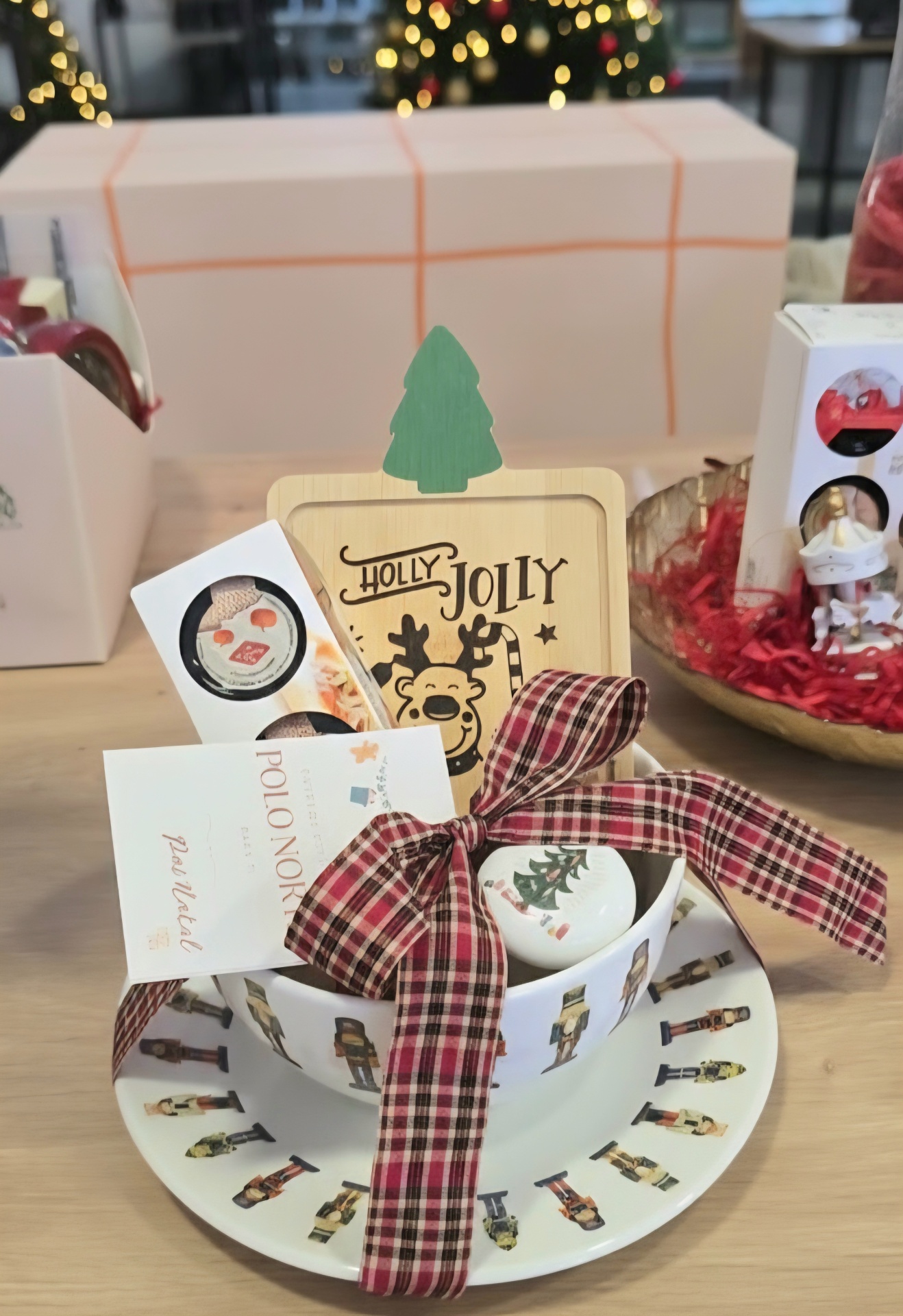 Conjunto de prato e taça com decoração de soldados, laço xadrez e tábua de madeira HOLLY JOLLY numa mesa