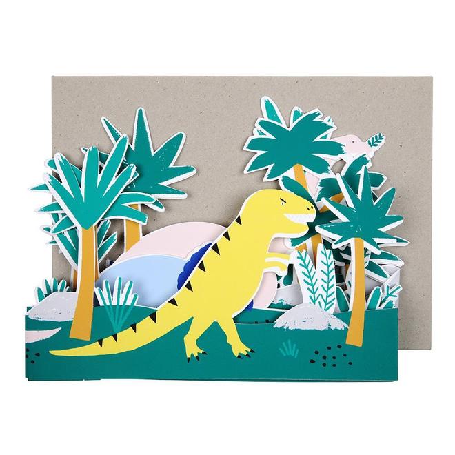 Cartão popup com dinossauro amarelo e árvores verdes em cenário colorido