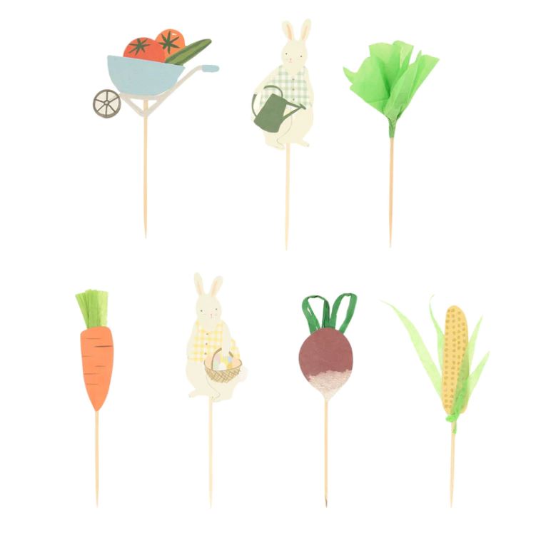 Espetos decorativos coloridos para bolos com motivos de legumes e coelhos.