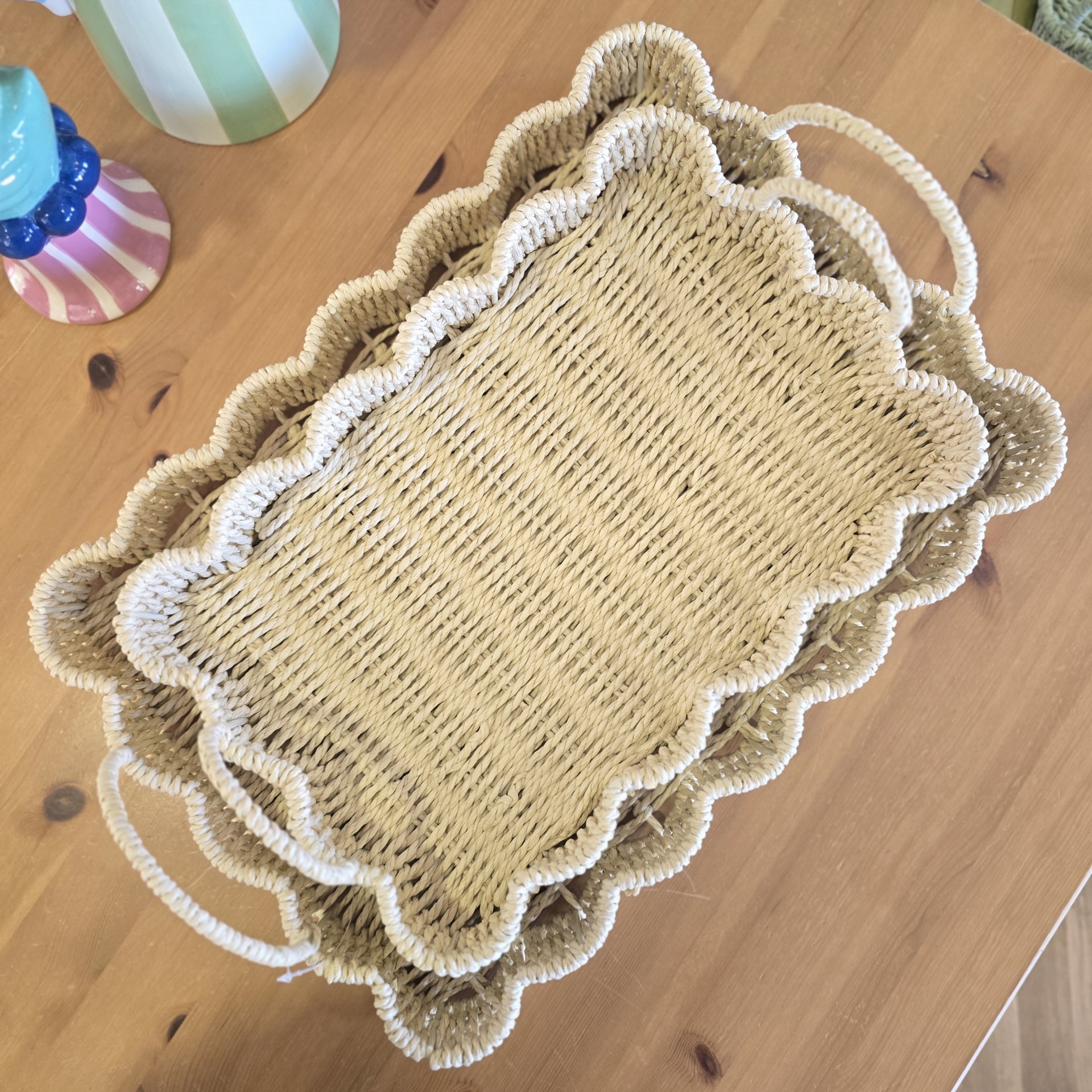 Conjunto de duas cestas retangulares de material natural com bordas onduladas