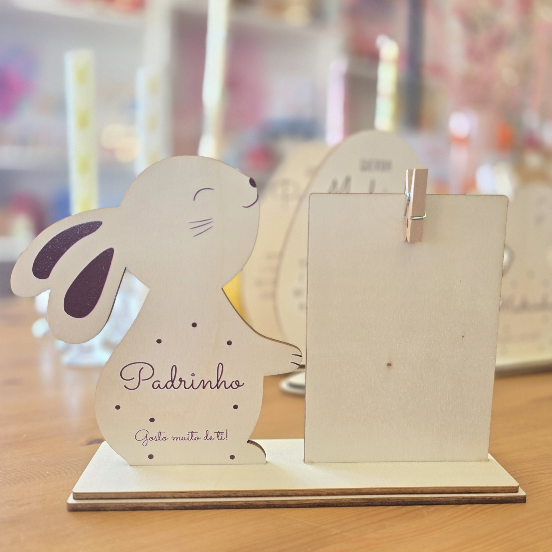 Suporte de madeira em forma de coelho com texto e painel com pregador para anotações