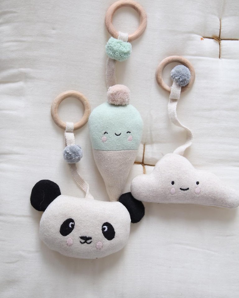 Brinquedos pendurados de tecido com argolas de madeira: panda, gelado e nuvem com rostos sorridentes