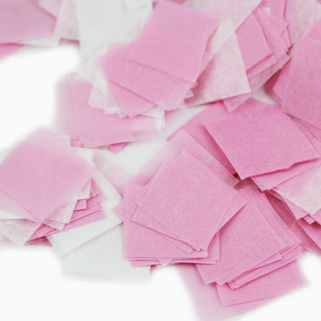 Quadrados de tecido não tecido rosa e branco empilhados