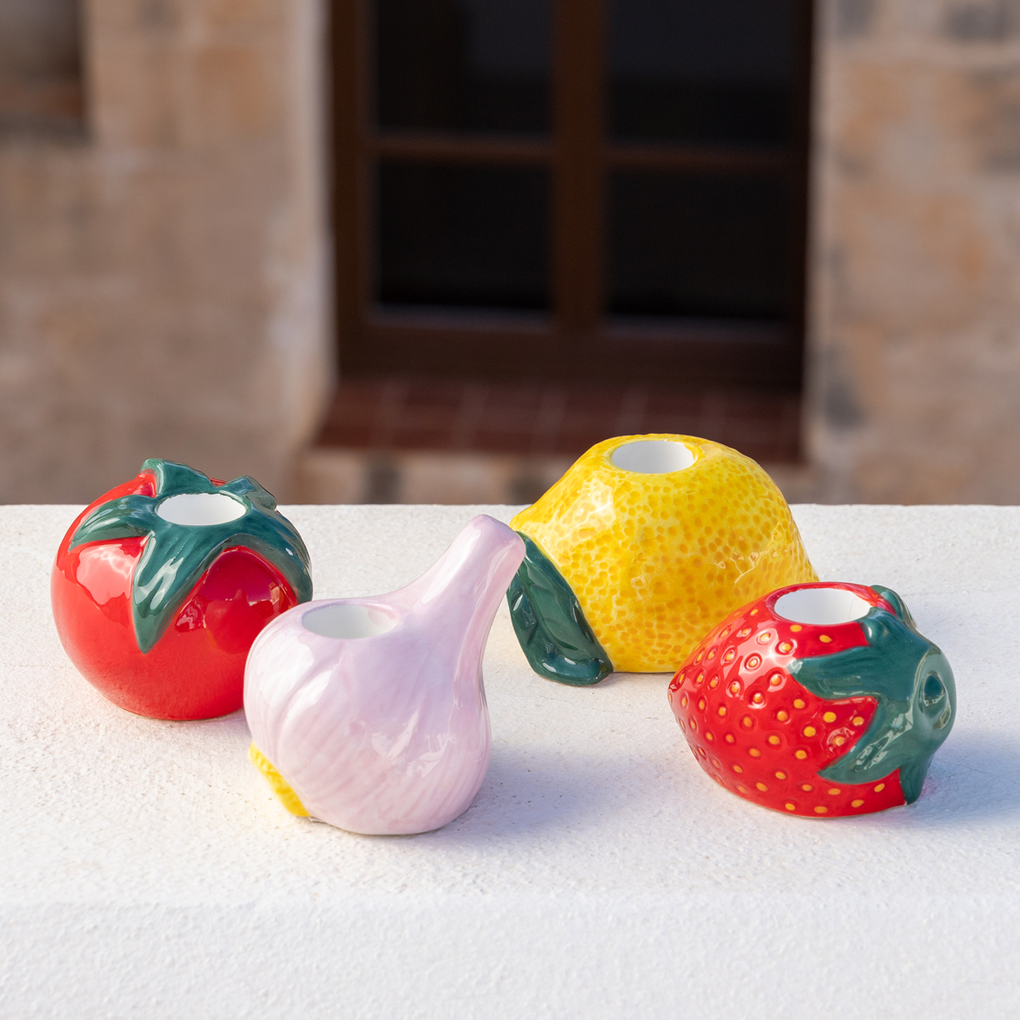 Conjunto cerâmico de castiçais em forma de frutas e legumes coloridos