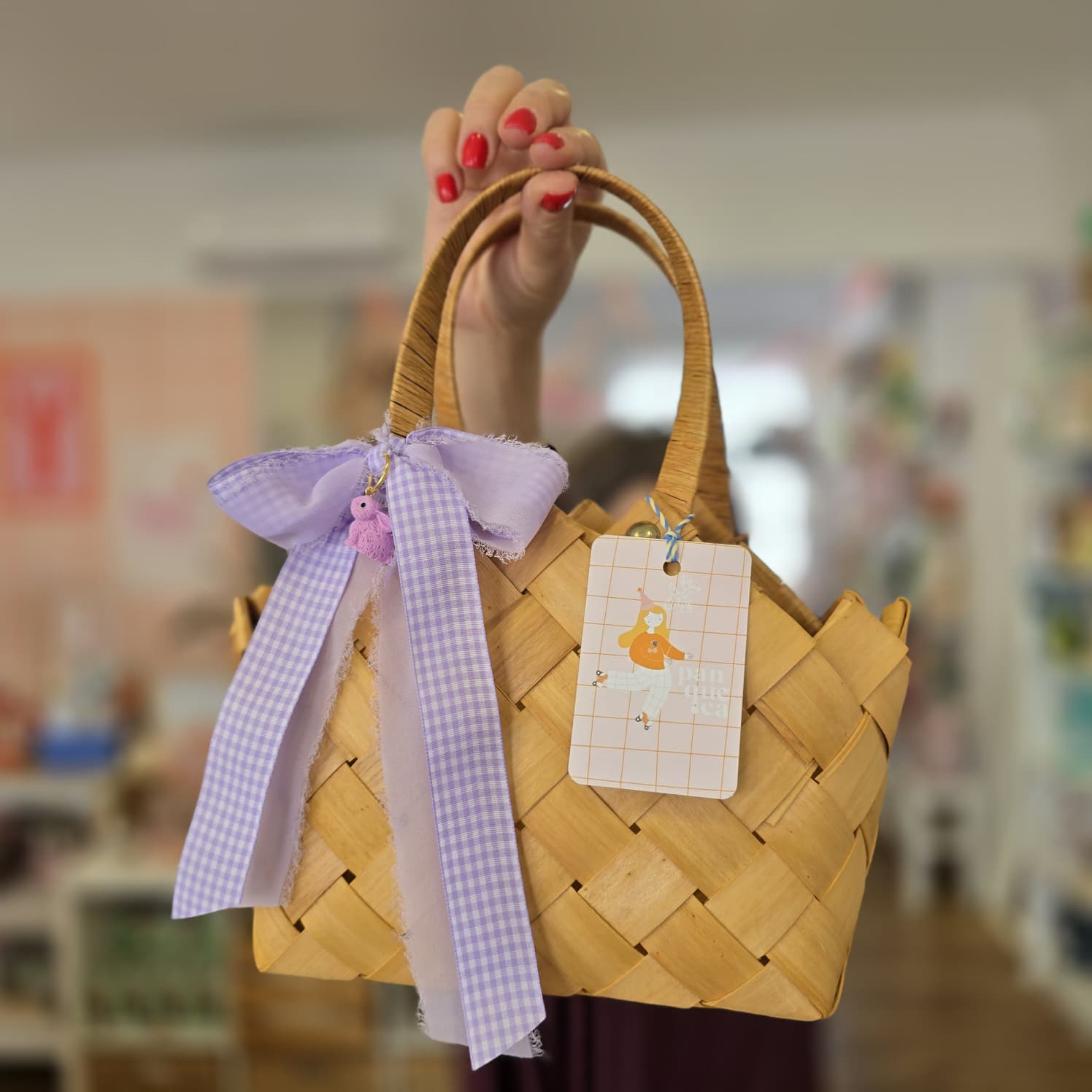 Mala de madeira trançada com fita roxa e etiqueta decorativa