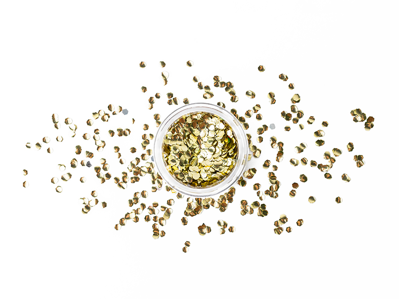 Pote transparente com lantejoulas douradas redondas espalhadas