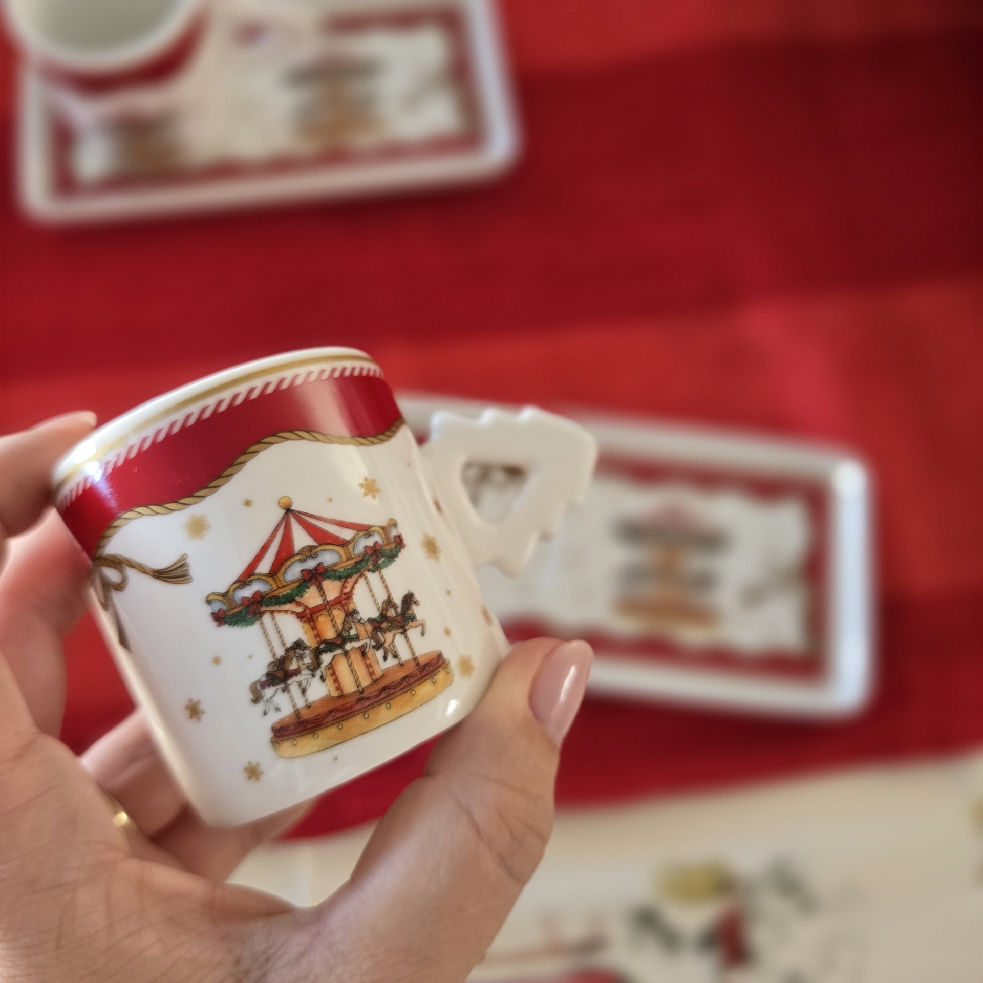 Caneca de cerâmica branca com decoração vermelha e dourada e carrossel impresso
