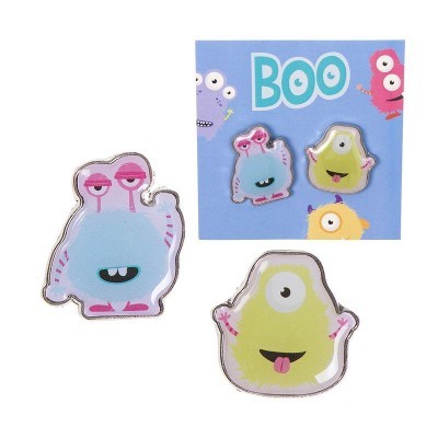 Conjunto de dois pins de monstros coloridos com cartão azul de fundo