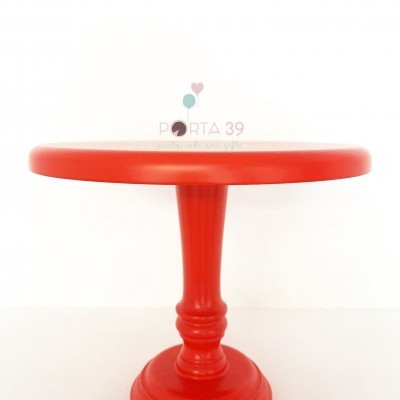 Suporte para bolos vermelho em madeira com base circular e coluna central trabalhada.
