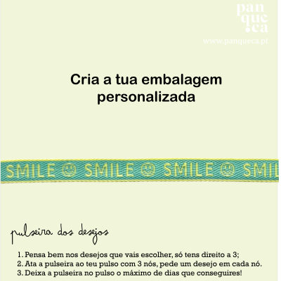 Pulseira azul com texto amarelo SMILE em fundo amarelo com texto em português sobre embalagem personalizada e pulseira dos desejos.