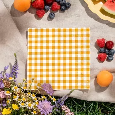 Guardanapo à mesa com frutas, flores e toalha cinza