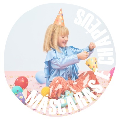 Criança com roupa colorida e chapéu de festa entre balões e confetes