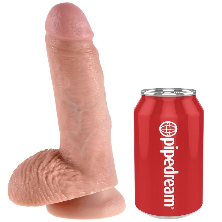 Dildo realista tom pele ao lado de lata vermelha com logótipo pipedream