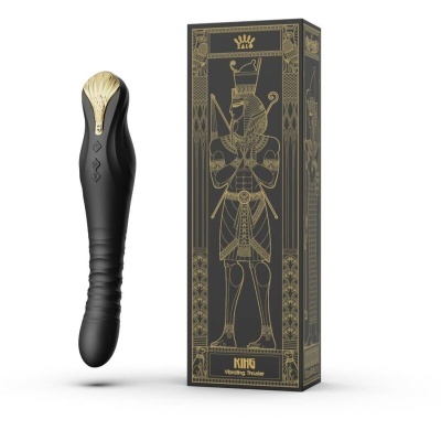Vibrador preto com detalhes dourados ao lado de caixa preta com ilustração dourada de um rei