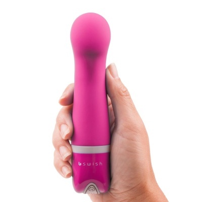 Vibrador rosa compacto em silicone com botão e texto 'bswish'