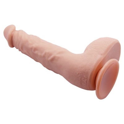 Dildo cor de pele com ventosa sobre fundo branco