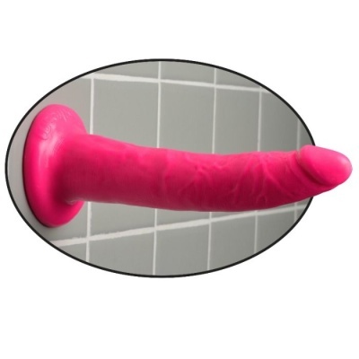 Dildo cor-de-rosa com ventosa sobre azulejos cinzentos