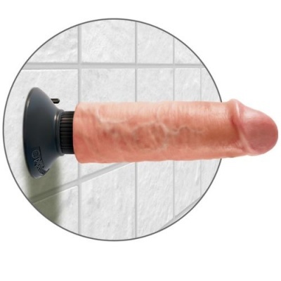 Dildo rosa com ventosa preta fixado numa parede de azulejos