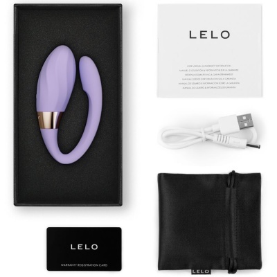 Produto eletrônico roxo em caixa preta com acessórios brancos e pretos e manual com texto LELO.