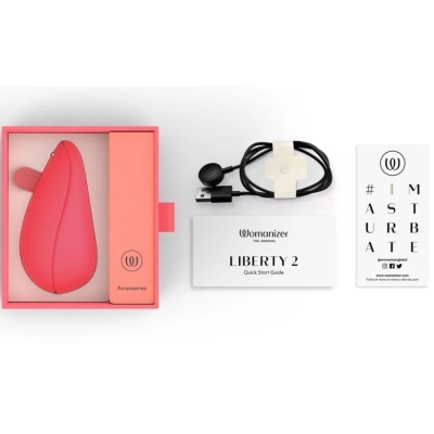 Produto feminino Womanizer Liberty 2 vermelho com estojo rosa e acessórios sobre fundo branco