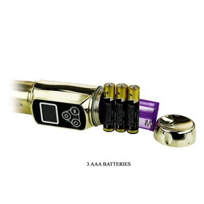 Aparelho dourado com visor digital e pilhas AAA ao lado.