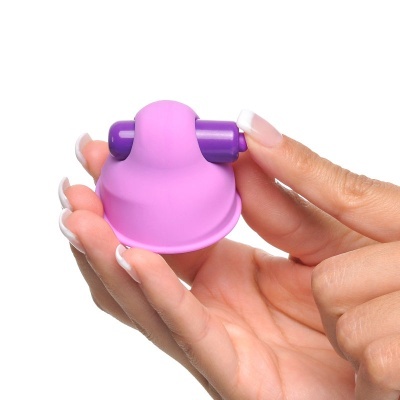 Objeto pequeno cor-de-rosa e roxo segurado por mão com unhas feitas